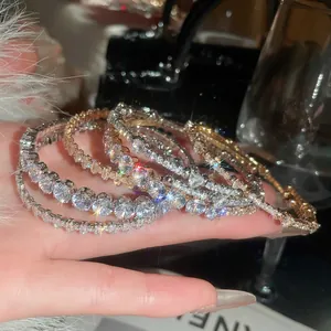 Elegant gold and silver bangles with sparkling zircon crystals in luxury social setting