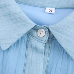 Elegant blue sleeveless shirt dress with pleated texture fabric and button detail