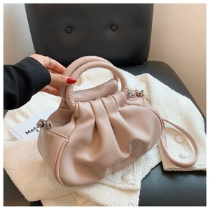 Pink pleated cloud bag with woven handle and long strap made of soft PU leather
