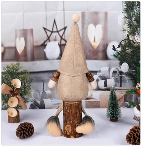 Detail of khaki linen Christmas gnome figurine with solid wood base for festive decor