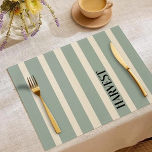 Close-up of sage green striped placemat with Harvest print and golden cutlery