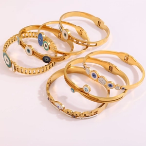 Gold stainless steel evil eye bracelets with blue rhinestones on a white background
