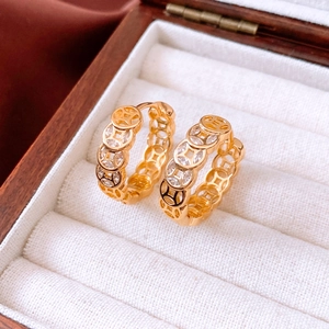 Detailed view of 18K gold plated hoop earrings with Chinese coin motif and zircon inlay