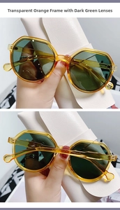 Detail view of transparent orange frame sunglasses with dark green lenses and C5 marking