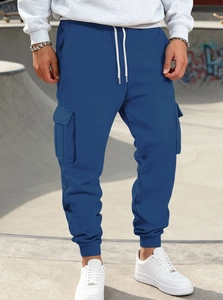 Detail view of blue American cargo joggers featuring large side pockets and ribbed cuffs
