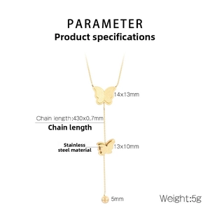 Detail of gold double butterfly pendant necklace in stainless steel with bead tassel