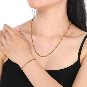 Minimalist gold titanium steel necklace and bracelet set featuring a classic round pearl charm