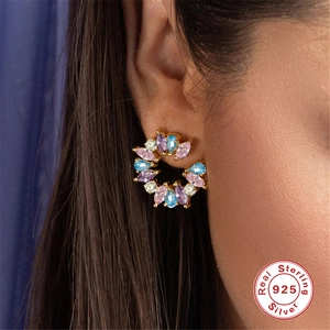 Sterling 925 silver stud earrings with colorful bezel-set crystals on model ear