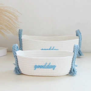 Detail of white cotton rope baskets with blue handles and goodday lettering