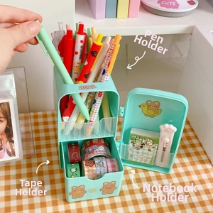 Detail view of mint green fridge-shaped organizer with stationery storage compartments