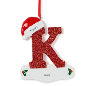 Close-up of glittery red letter K Christmas tree ornament with a Santa hat detail