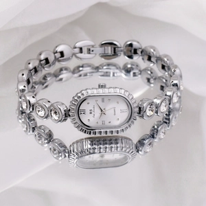 Close-up of luxury silver oval quartz watch with crystal-encrusted link bracelet detail