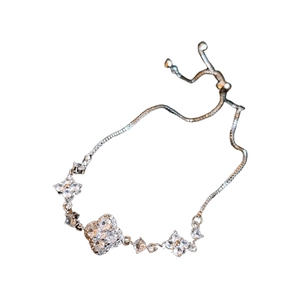 Silver flower bracelet featuring sparkling zircon stones on a clean white background