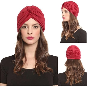 Detailed views of red pleated turban cap showing front, side and back fit on woman