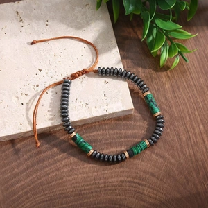 Adjustable beaded bracelet with grey stone and green tiger eye beads on braided cord