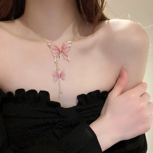 Close-up of elegant pink tulle butterfly tassel necklace on model's collarbone
