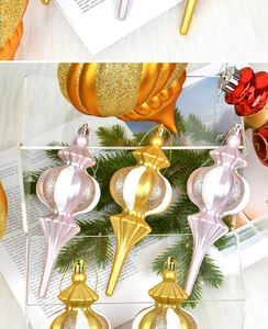 Detailed close-up of festive red and gold ornaments with varied textures and finishes