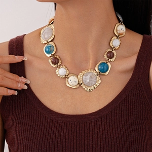 Close-up of vintage resin necklace with geometric stones on golden metal base