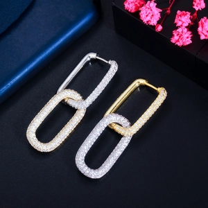 Luxe gold and silver rectangle link earrings with pave cubic zirconia on dark surface