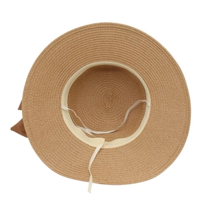 Detail view of woven straw hat interior with sweatband and elastic chin strap