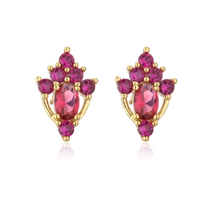 Macro shot of gold-plated earrings featuring red oval zircon stones in a royal crown design
