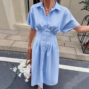 Close-up of blue and white striped shirt dress with waist pleats and button detailing