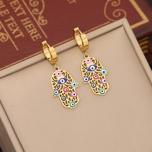 Golden Hamsa Hand earrings with colorful enamel evil eyes displayed on a jewelry stand