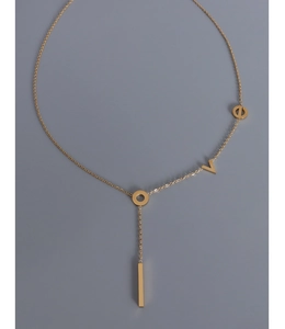 Detailed close-up of a gold-plated Y-shaped necklace with geometric pendants and circle link