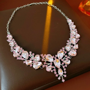 Macro detail of vintage pink teardrop crystal necklace on premium leather display