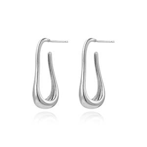 Detailed close-up of shiny silver-tone U-shaped earrings with a smooth polished surface