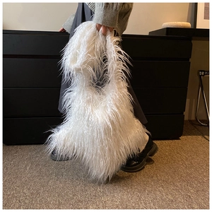 Detail shot of white faux fur handbag showing soft shaggy texture and plush material