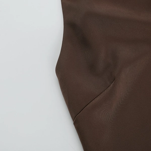 Close-up of the dark brown fabric texture and durable stitching on the bodycon dress