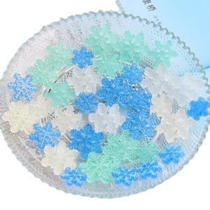 Glittery translucent resin snowflakes in white, green, and blue for DIY jewelry crafts