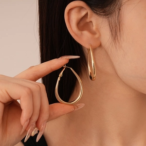 Minimalist polished gold teardrop hoop earrings with high-gloss metallic finish for women