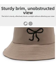 Detail of khaki bucket hat with black bow and stiff brim for optimal sun protection