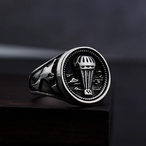 Vintage stainless steel ring featuring parachute relief and engraved feather details