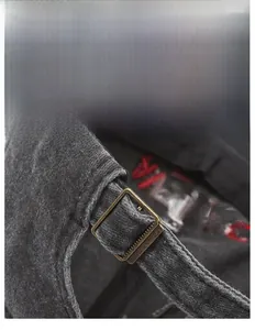 Detail of adjustable metal buckle and red embroidery on washed cotton baseball cap