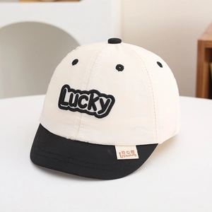 Detail view of Lucky letter embroidery and contrast stitching on children's baseball cap