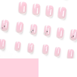 Short French press-on nails with light pink gloss and minimalist rhinestone accents
