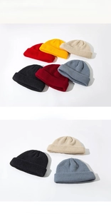 Detailed view of knitted beanies in various colors like red, yellow, and beige texture
