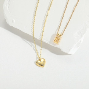 Minimalist 18K gold necklaces featuring a heart pendant with small diamonds and pearls