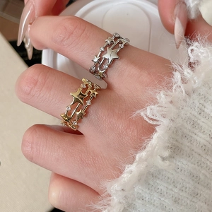 Macro view of triple-layer star ring with zircon inlay and golden metallic finish