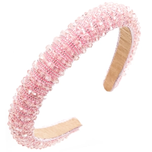 Detailed close-up of pink handcrafted beads on a wide baroque rhinestone headband