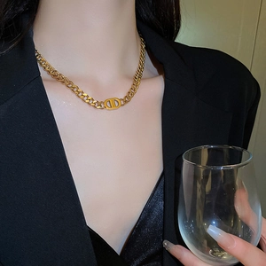Golden Cuban link necklace with CD pendant shown on a model wearing a black blazer