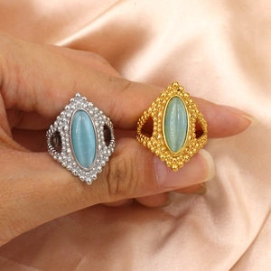 Vintage bohemian titanium steel rings with oval turquoise stones on peach silk