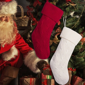 Detail of red and white knitted Christmas stockings with embossed rhombus texture patterns