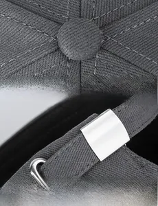 Detail view of cotton baseball cap showing top button stitching and metal strap buckle