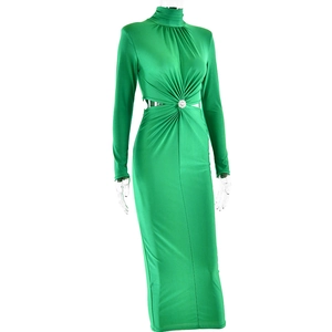 Détail de la robe verte à col montant avec découpe à la taille, fronces et boucle strass