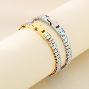 Close-up of gold and silver titanium bracelets with colorful rectangular zircons and buckle