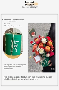 Detail of dark green Christmas gift bucket with golden ribbon and white floral decor